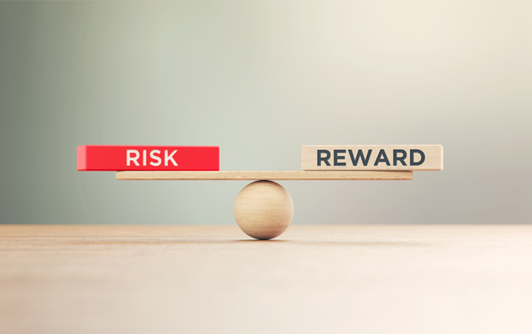 Image of a balance beam where the left side represents risks and the right side represents rewards.
