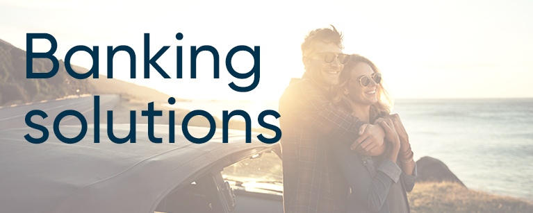 Image of a couple on the beach with the title Banking solutions