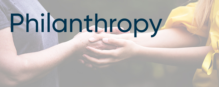 Image of two women joining hands with the title Philanthropy