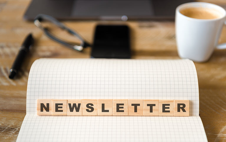 Image of block letters placed on a sheet of paper spelling out the word newsletter.